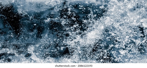 Ice texture background. The textured cold frosty surface of ice block on black background. - Shutterstock ID 2086122193