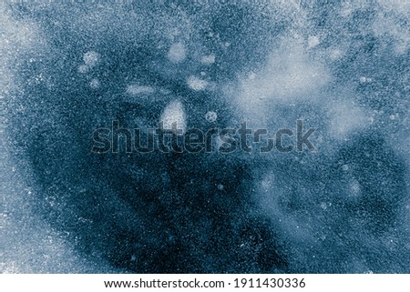 Ice texture background. Textured cold frosty surface of ice on dark background.