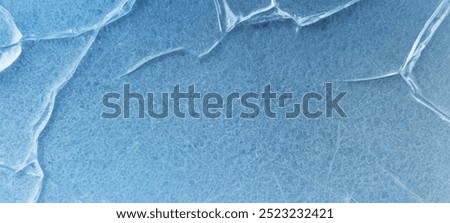 Ice texture. Blue backdrop with cracks and scratches on frozen water. ice background