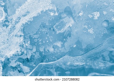 Ice texture in blue tones. Natural background. The textured cold frosty surface of the ice.
