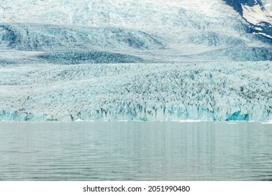 Ice wall and icebergs in Fjallsarlon glacier lagoon, abstract landscape, Iceland