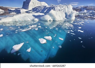 Iceberg Floating In Greenland Fjord.