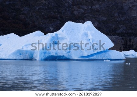 Iceberg, image of a block of ice separated from the glacier. Lake Grey, Torres del Paine National Park, Chile. Patagonia, Puerto Natales. Melting glaciers, climate change, environment global warming. 