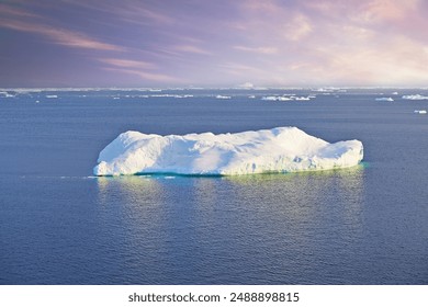 Iceberg, landscape and nature in Arctic for wallpaper, ocean and sunrise in Greenland. Global warming awareness, melting ice and climate change on Earth with effects, broken glacier and frozen water - Powered by Shutterstock
