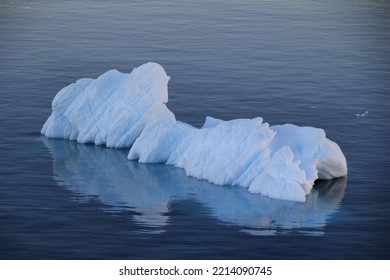 Iceberg Reflection In Dark Arctic Ocean