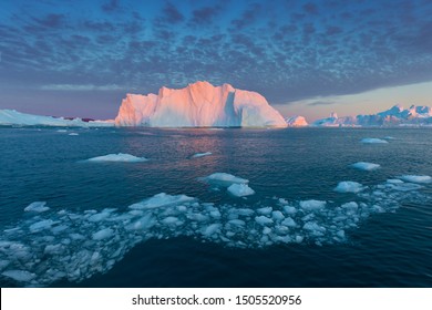 Iceberg at sunset. Nature and landscapes of Greenland. Disko bay. West Greenland.
Summer Midnight Sun and icebergs.
Big blue ice in icefjord. Affected by climate change and global warming. - Powered by Shutterstock