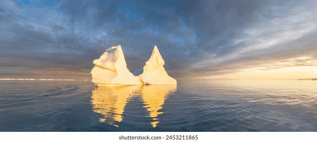 Iceberg at sunset. Nature and landscapes of Greenland. Disko bay. West Greenland. Summer Midnight Sun and icebergs. Big blue ice in icefjord. Affected by climate change and global warming. - Powered by Shutterstock