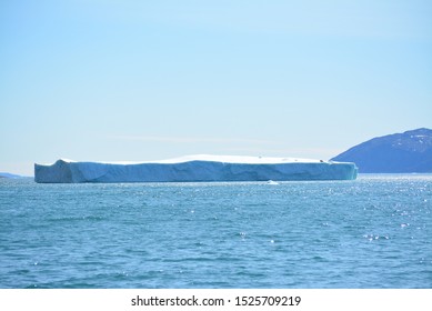 icebergs in the arctic sea from the Eqip Sermia - Eqi Glacier in Greenland. Boat trip in the Disko Bay. World heritage -  extremly affected by global warming and climate change. Summer - July - Powered by Shutterstock