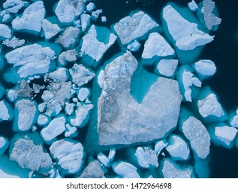 Icebergs drone aerial image top view - Climate Change and Global Warming. Icebergs from melting glacier in icefjord in Ilulissat, Greenland. Arctic nature ice landscape in Unesco World Heritage Site. - Powered by Shutterstock