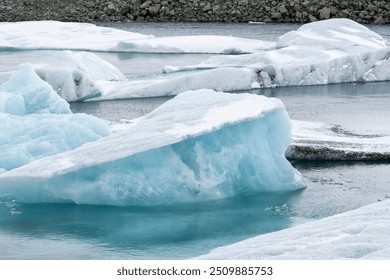 Icebergs floating in Jokulsarlon  . Jokulsarlon (glacial river lagoon) is a large glacial lake in southeast Iceland, on the edge of Vatnajokull National Park. - Powered by Shutterstock