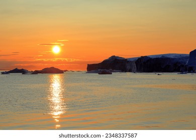 Icebergs in Icefjord at midnight sun, Disko Bay, Ilulissat, Greenland