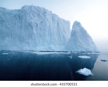 Icebergs In Ilulissat At Foggy Day. You Can Easily See That Iceberg Is Over The Water Surface, And Below The Water Surface. Sometimes Unbelievable That 90% Of An Iceberg Is Under Water 