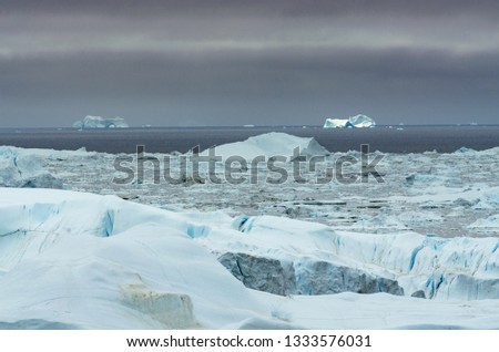 Icebergs in the mouth of Ilulissat Icefjord and the open sea, two iceberg gates in the background, Greenland