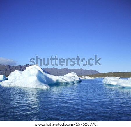 Icebergs on Jokulsarlon lagoon, Iceland against the mountains