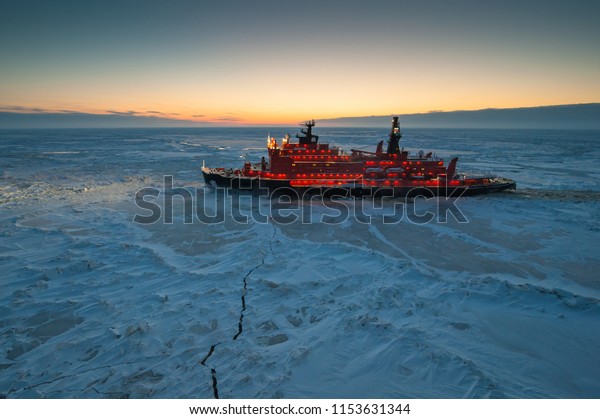 Icebreaking\
vessel in Arctic with background of\
sunset