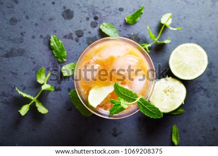 An ice-cold Peach Drink with Lime and Mint
