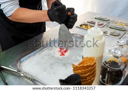 ice-cream with fruit in manual grinding and preparation from the obtained mass of rolls