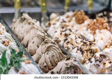Ice-cream and sorbet stand in shop with different flavors of Italian Gelato. Close up view.