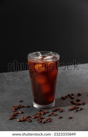 Iced americano coffee with beans background