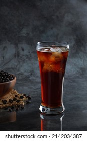 Iced Americano Coffee In The Glass With Coffee Beans In Background. Diet Drink Or No Sugar Concept.