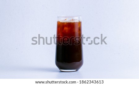 Iced americano in glass isolated on white background closeup.