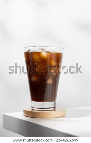 Iced americano in a glass on a white table