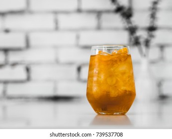 Iced Apple Juice Spritzer With White Brick Wall