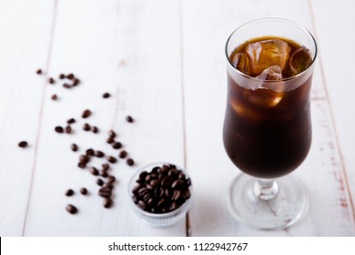 Iced Black Coffee On White Wooden Table