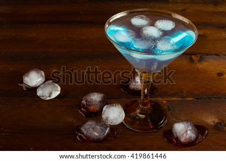 Iced blue margarita cocktail. Blue cosmopolitan martini cocktail. Blue Lagoon Hawaiian cocktail. Blue curacao liqueur.