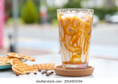 Iced Caramel Latte Coffee In A Tall Glass With Caramel Syrup