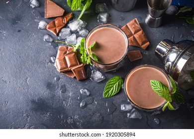 Iced Chocolate Cocktail. Summer Refreshment Drinks. Chilled Iced Chocolate Coco Drink, Latte Coffee. With Ice, Mint And Chocolate Slices On Dark Background Copy Space