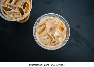 Iced Coffee Beverage Top Down View. Dark Tabletop Background.