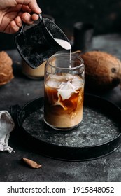 Iced Coffee And Coconut Milk In A Transparent Glass