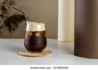 Iced Coffee. Coffee Cold Brew Drink Cocktail With Ice Cube And Straw On Abstract Background. Summer Refreshing Drink Concept.