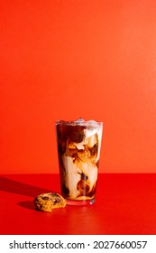 Iced Coffee With Cream On A Bright Red Background With A Cookie