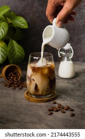 Iced Coffee Milk Or Kopi Susu Pouring With Condensed Milk On Texture Grey Background