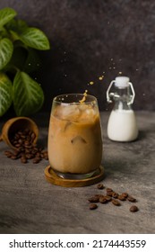 Iced Coffee Milk Or Kopi Susu Pouring With Condensed Milk On Texture Grey Background