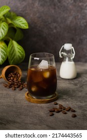 Iced Coffee Milk Or Kopi Susu Pouring With Condensed Milk On Texture Grey Background