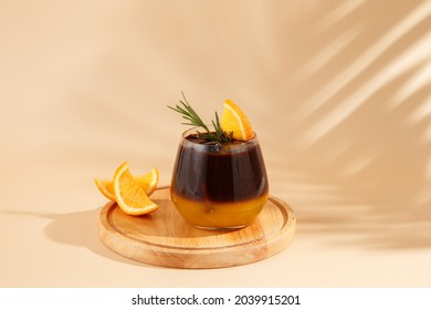 Iced coffee mixed with orange juice, two tones layer decoration with rosemary and piece of orange - Shutterstock ID 2039915201