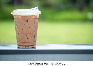 Iced Coffee Mocha In Plastic Glass With New Lid Design For Don't Use Drink Straw. Concept Of Reduce The Use Of Plastic Straw.