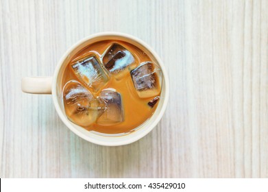 Iced Coffee In Mug On Wooden Table, Top View