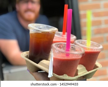 Iced coffee and smoothies being picked up from a drive thru window