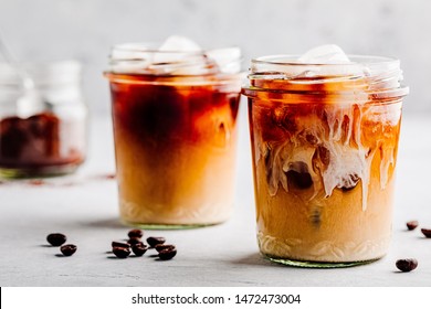 Iced Coffee with Vanilla Cardamom Almond Milk on gray stone background