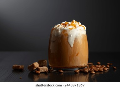 Iced coffee with whipped cream and caramel sauce on a black background. Copy space. - Powered by Shutterstock