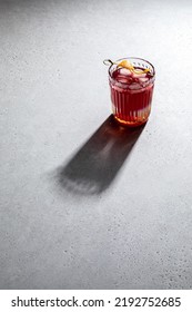 Iced Cold Lemonade In Glass With Shadow Isolated On Concrete Tabletop. Abstract Background