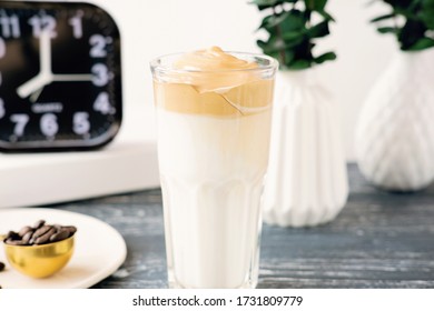 Iced Frothy Dalgona Coffee, A Trendy Fluffy Creamy Whipped Coffee. Korean Drink Latte Espresso With Coffee Foam. Cups And Spoon With Instant Coffee And Alarm Clock