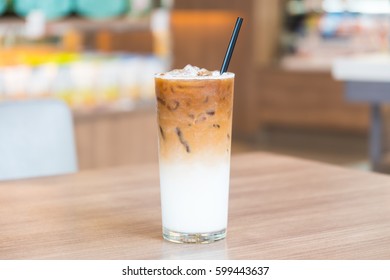 Iced Latte Coffee Glass On Wooden Table In Restaurant And Cafe