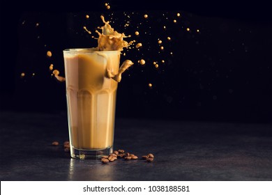 Iced Latte Coffee Glass With Splash On A Black Background