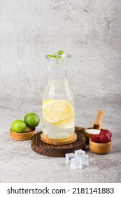 Iced Lemon With Sparkling Soda Water On Wooden Coaster And White Background Texture