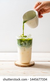 iced matcha latte green tea on wood background